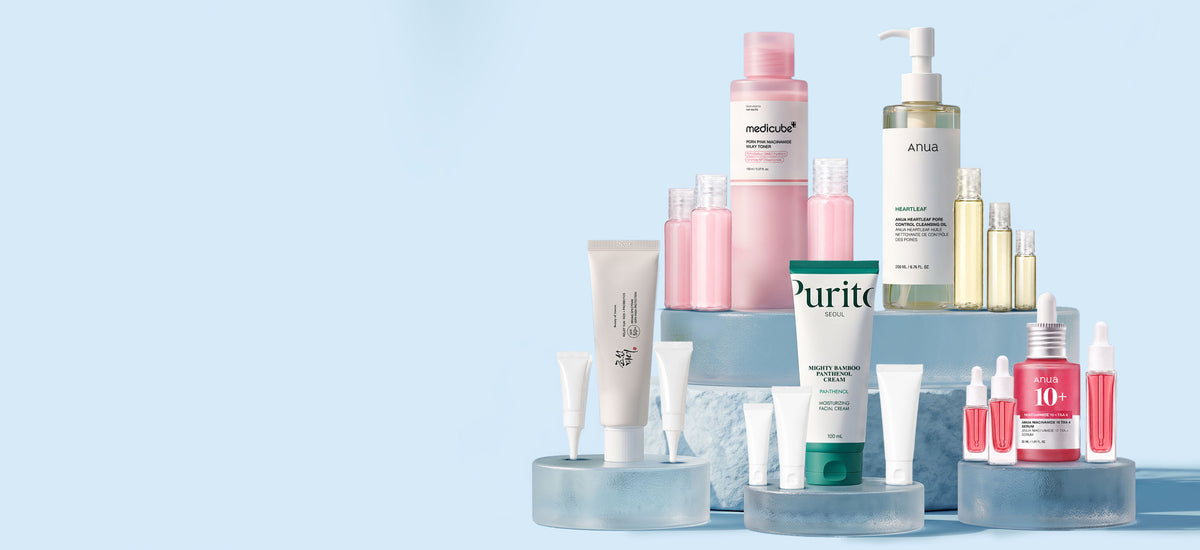 Korean skincare sample bottles and tubes arranged on a light background